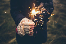 Woman With Gloves Holding A Sparkler 