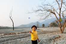 Child Playing With Paper Plane
