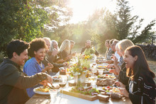Group Of Friends Enjoying A Farm To Table Dinner Party