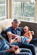 © Trinette Reed/Stocksy - Portrait of father and son having fun and connecting in living room
