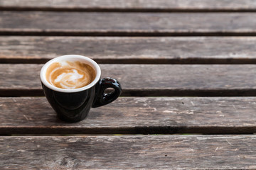 Wall Mural - cup of coffee on wood table background