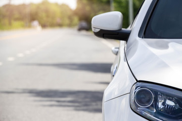 close up front of white car on the road