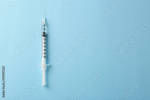 Foto  Medical syringe on color background