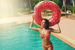 © blackday - Sexy woman and inflatable swim ring in shape of donut