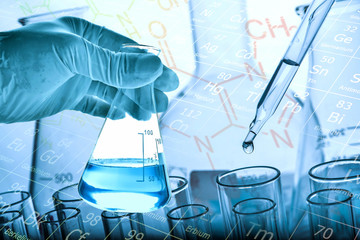 Wall Mural - flask in scientist hand with test tubes background