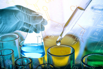 Wall Mural - flask in scientist hand with test tubes background