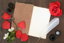 Red Rose Flower And Petals With Hemp Notebook, Old Quill Feather Pen And Ink, With Orange Blossom And Essential Oil Bottles On Old Oak Background.