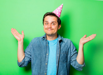 Wall Mural - Handsome smiling man with birthday boy cap