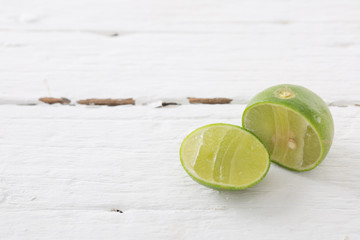  Fresh lime cut in half on white table