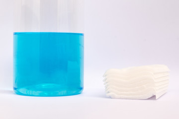 cotton bandage and blue alcohol for medical in the plastic bottle on white background