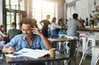 © wayhome.studio  - Cheerful black student with stylish Afro haircut smiling broadly while reading message from his girlfriend on cell phone, browsing internet during lunch break while doing homework at coffee shop