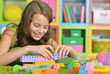 © aletia2011 - Cute girl playing with colorful plastic blocks