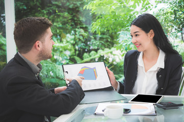 Wall Mural - Businessman meeting with business woman at office to discuss marketing situation 