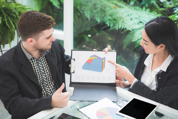 Wall Mural - Businessman meeting with business woman at office to discuss marketing situation 