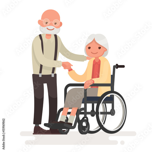 Couple Of Elderly People Grandpa Near Grandmother In A Wheelchair