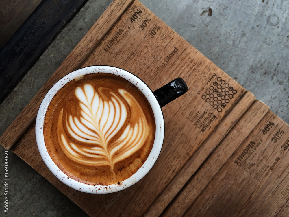 Nice Texture of Latte art on hot latte coffee . Milk foam in heart shape leaf tree on top of latte art from professional barista artist - obrazy, fototapety, plakaty 