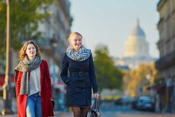 Wall Mural - Two young girls walking together in Paris