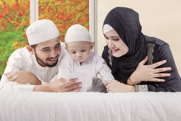 Canvas Print - Happy family watching video with autumn