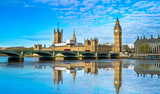 Fototapeta Londyn - Big Ben and Westminster parliament with blurry refletion in London, United Kingdom at sunny day.