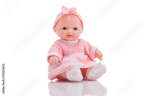 Photographie Cute little plastic baby doll with blue eyes sitting isolated on white backgrou