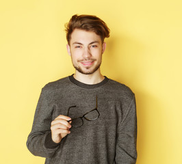 Poster -  Young  trendy man with glasses smiling, studio shot