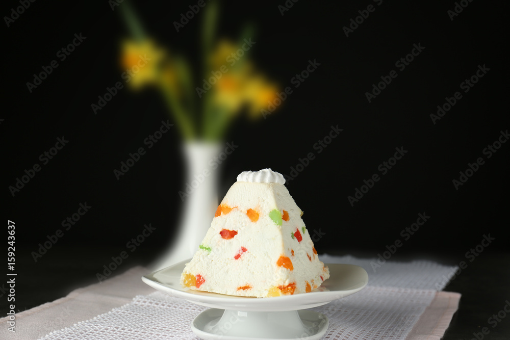 Traditional curd Easter cake with candied fruits on black background