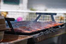 Salmon Steaks Smoking On An Outdoor BBQ Grill