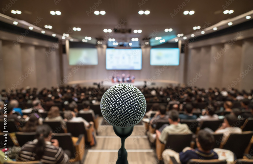 Microphone over the Abstract blurred photo of conference hall or seminar room with attendee background, Business meeting concept - obrazy, fototapety, plakaty 