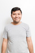 © wacharaphong - Smiling Asian man in gray t-shirt