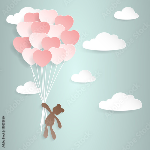 teddy bear hanging from balloons