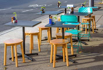 Wall Mural - Chairs and tables of a outdoor street cafe in Northcote, Melbourne, Australia