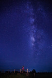 Fototapeta Kosmos - woman stand under milky way watch night sky