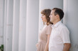 © liliyabatyrova - a love story, a man and a woman wearing light clothes, standing near a grey wall, profile, hug, family, a date, a walk