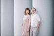 © liliyabatyrova - love story, beautiful couple a man and a woman in bright clothes, dress standing near a gray wall, hugging, smile, family, a date, a walk