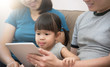 © eggeeggjiew - Happiness of Asian  family sitting and playing digital tablet together.