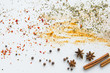 Close-up view of dried aromatic spices and herbs scattered on grey