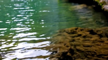 Sticker - The clear water surface of Aksu river and the river bed under the ripple, Antalya, Turkey.
