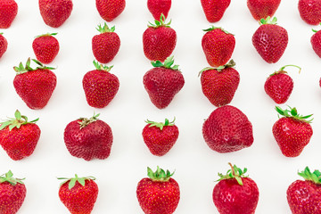 Red juicy strawberry on white background. Summer berries. Food pattern