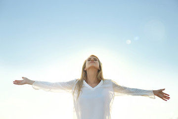 Happy young woman on sky background