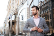 © Drobot Dean - Portrait of a young handsome man buttoning his jacket