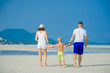 © schamin - Happy young family of three having fun on the desert sunny beach