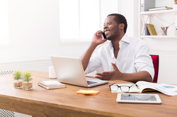 Wall Mural - Young black businessman call mobile phone in modern white office