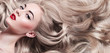 Beautiful young well-groomed girl lies - close-up. Long light shiny healthy well-groomed long hair. Advertising of hair care, cosmetics, beauty. Makeup - red lips, black arrows, mascara.