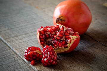 Wall Mural - Ripe pomegranate fruit on wooden vintage background.