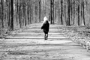 Black-and-white photo in retro style with an escaping little child