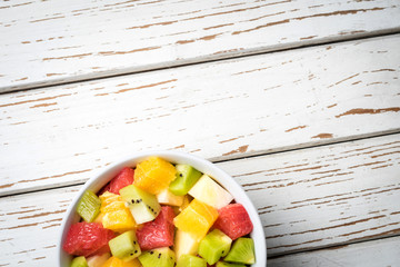 Sticker - Fresh fruit salad on an old white wooden table