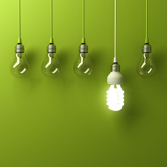 one hanging energy saving light bulb glowing different standing out from unlit incandescent bulbs wi