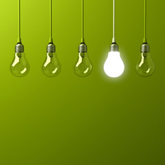 Fototapete - One hanging light bulb glowing different and standing out from unlit incandescent bulbs with reflection on green background , leadership and different business creative idea concept. 3D rendering.