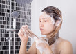 © geargodz - unhappy woman washing head with shampoo and shower