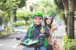 © Odua Images - commercial motorcycle taxi driver and his passenger showing thumb up